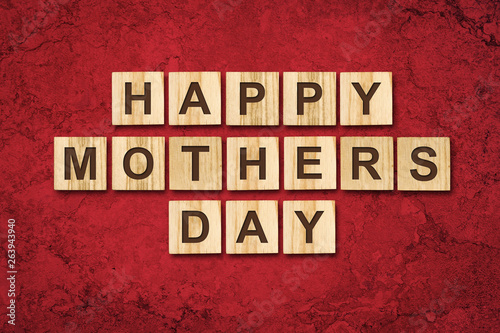 Happy Mother's Day, word written on wooden blocks. Red background Congratulatory background. Holiday card.
