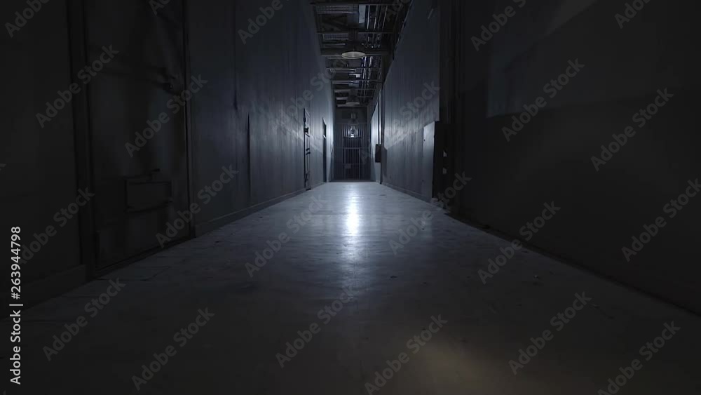 camera walking in the path inside prison with cells