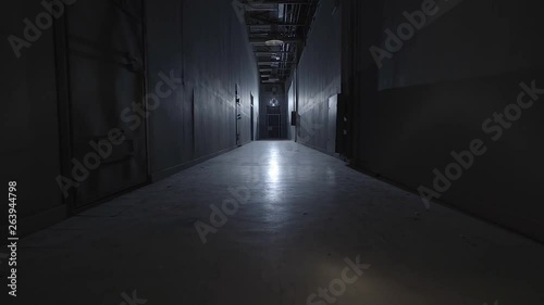 camera walking in the path inside prison with cells photo