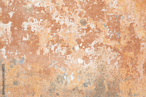 Old beige chipped wall texture background in Italy
