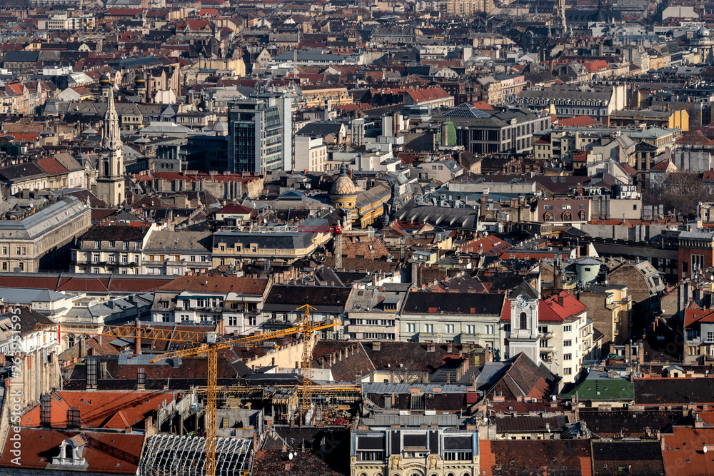 Hungary, Budapest: Skyline from above and mass of houses, buildings, apartments, rooftops in the city center of the Hungarian capital - concept urban development town planning structure.