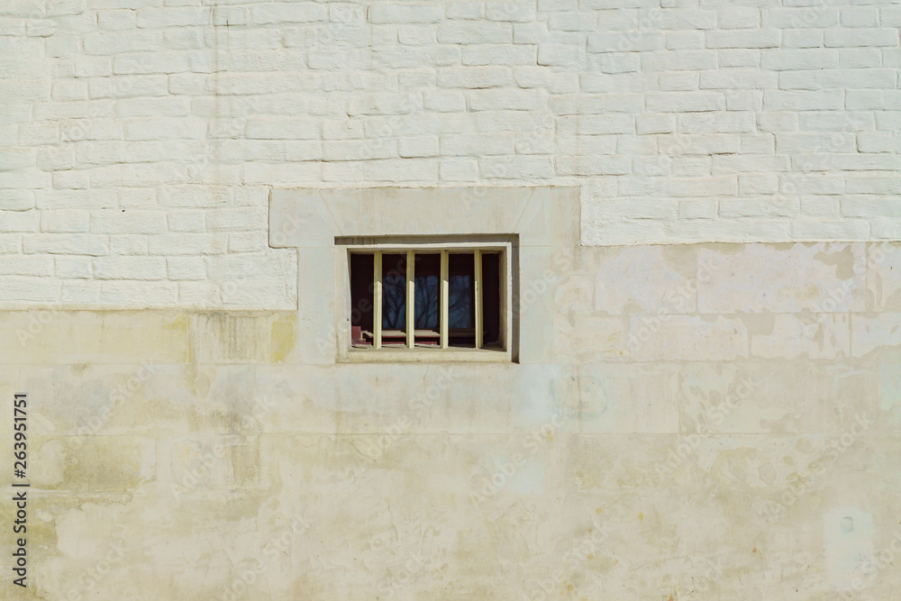 White brick wall and small window in the middle. Backgound texture White brick wall and small window in the middle. Backgound texture