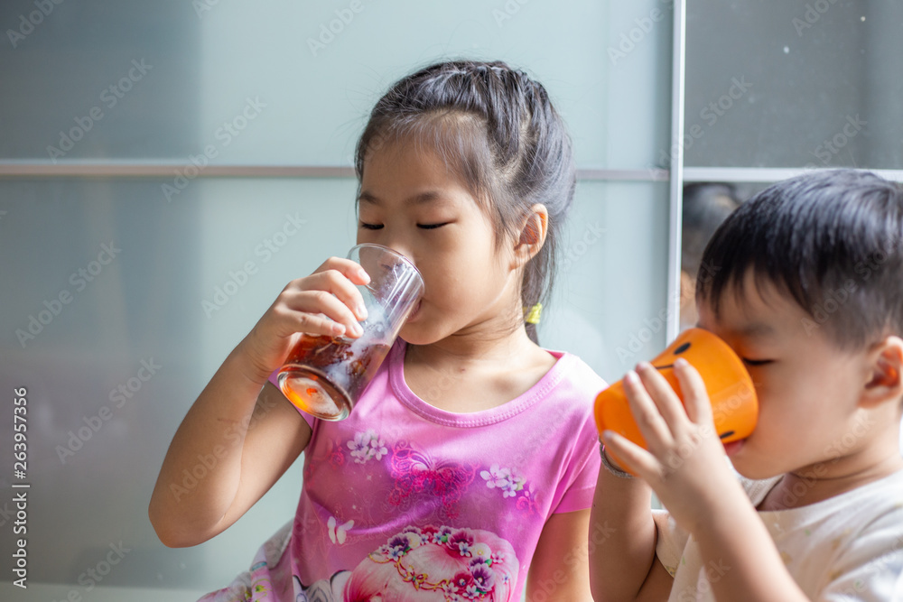 Funny child boy and girl drinking sweet ice drink Funny child boy and girl drinking sweet ice drink