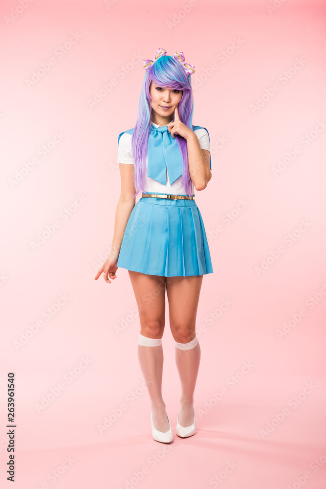 Full length view of otaku girl in purple wig smiling on pink Full length view of otaku girl in purple wig smiling on pink