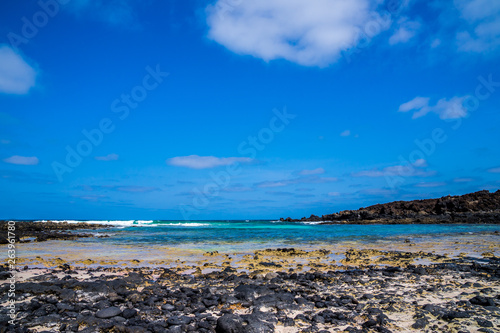 Spain, Lanzarote, Perfect little cove of white sand beach and black lava stones at north coast