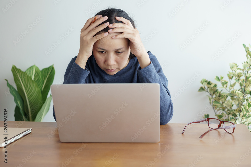 Asian women stressful working with a computer for a long time, Office syndrome concept Asian women stressful working with a computer for a long time, Office syndrome concept