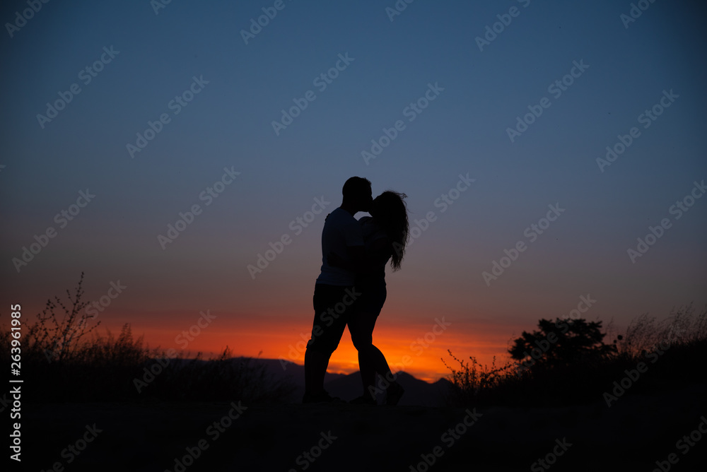 Young couple enjoying the sunset.
