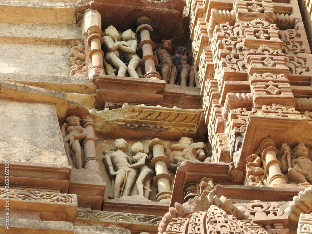 Fototapeta premium Sex poses from the kamasutra, erotic close - up of intricate carved scenes on the walls of Hindu temples in the Western group of Khajuraho, India