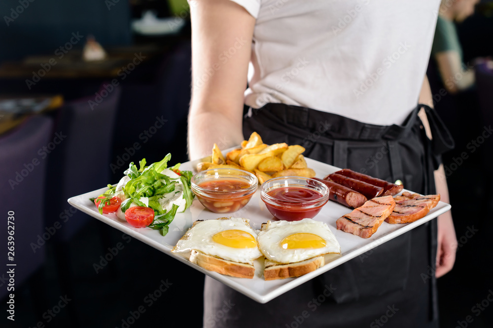 Waitress serving breakfast at a restaurant