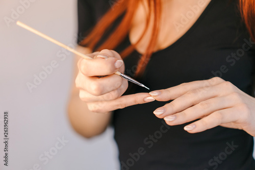 Woman during manicure procedures