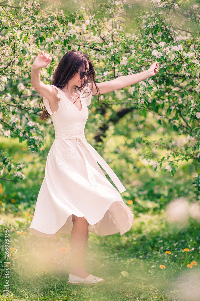 Beautiful woman enjoying smell in spring cherry garden Beautiful woman enjoying smell in spring cherry garden
