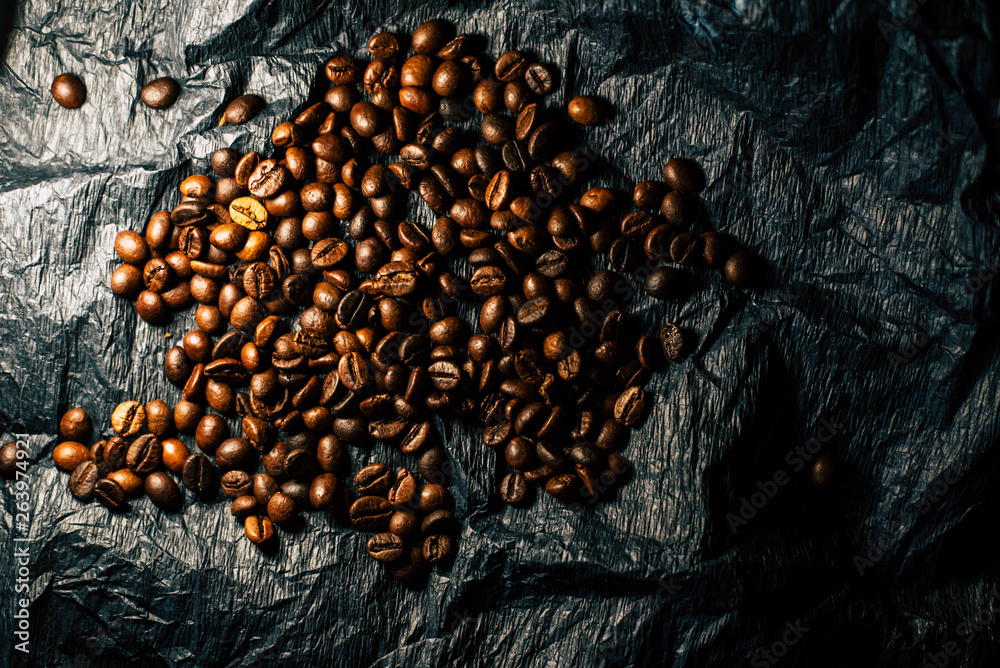 Coffee grains on a black background with a cup Coffee grains on a black background with a cup