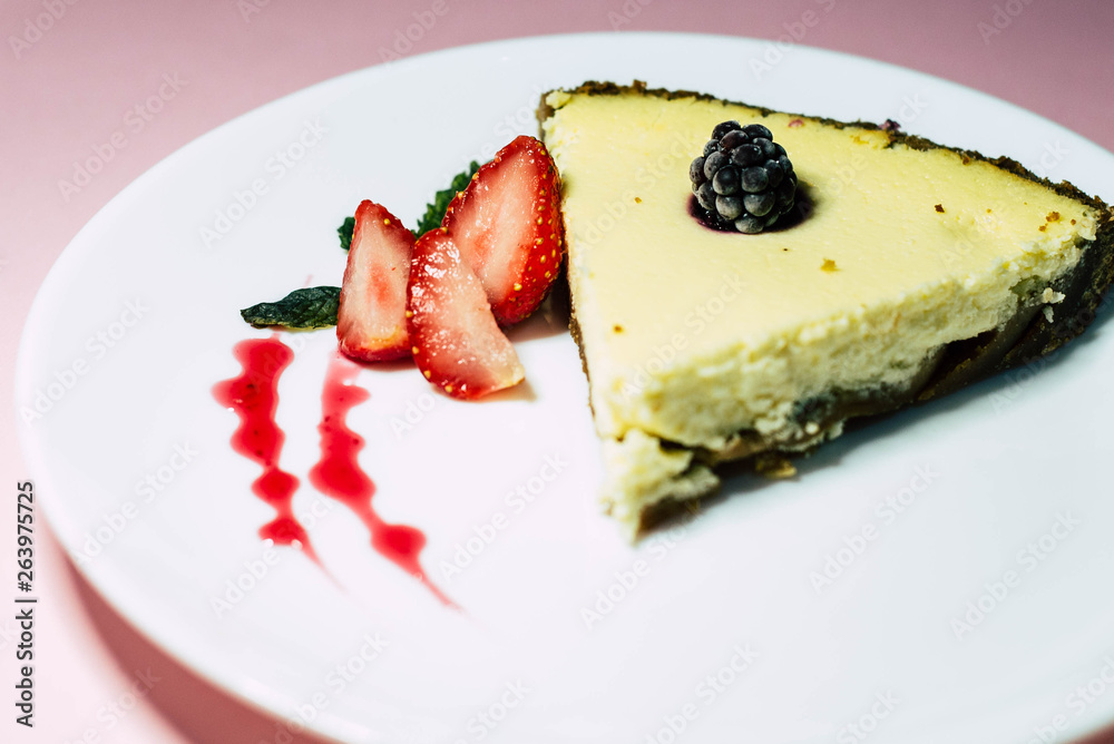 cheesecake with berries on a white plate