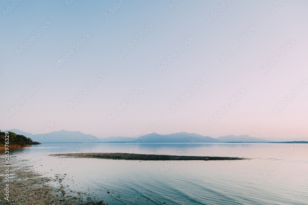 Amazing sunset in chiemsee lake with mountains in background