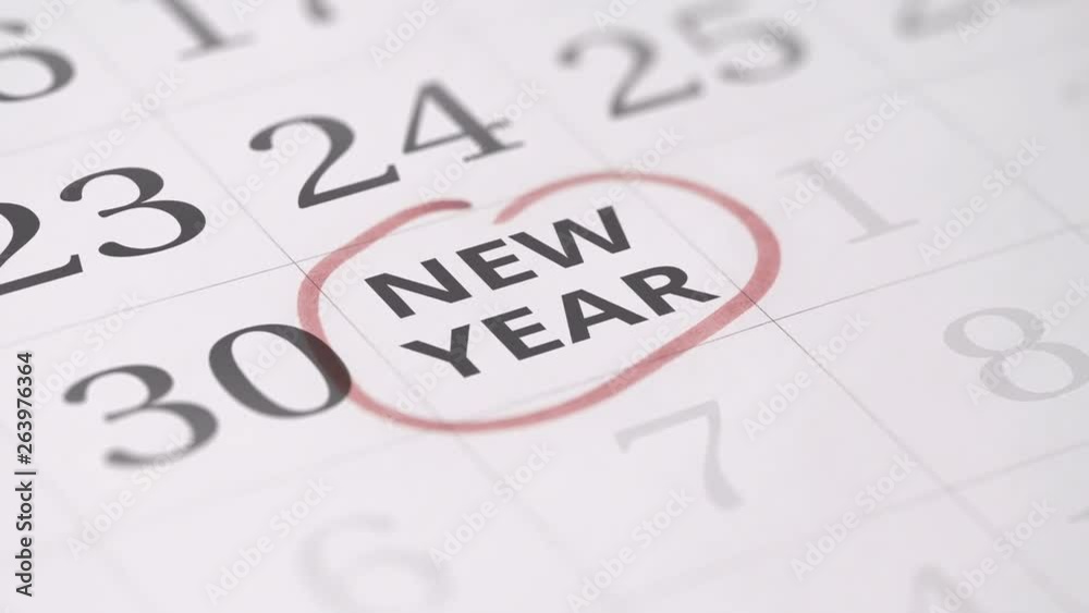 Marked date in the calendar transforms into NEW YEAR words Marked date in the calendar transforms into NEW YEAR words