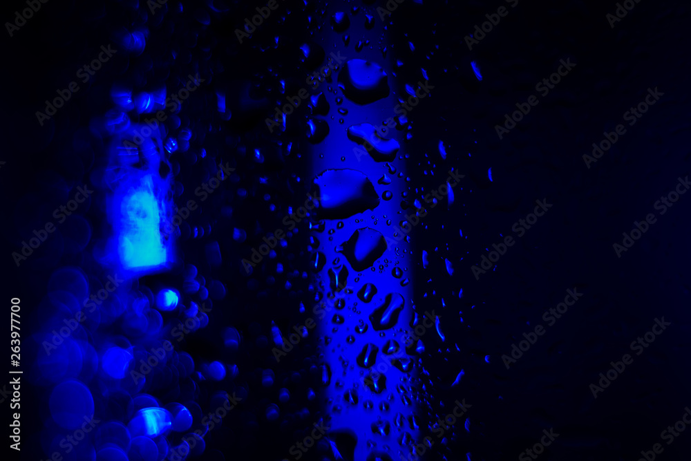 dark blue drops on the glass surface, macro, abstraction