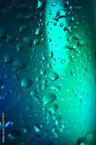 blue with a turquoise drop on a glass surface  macro  abstraction