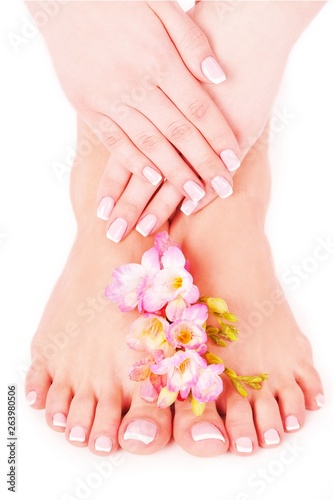 Relaxing pink manicure and pedicure with a orchid flower