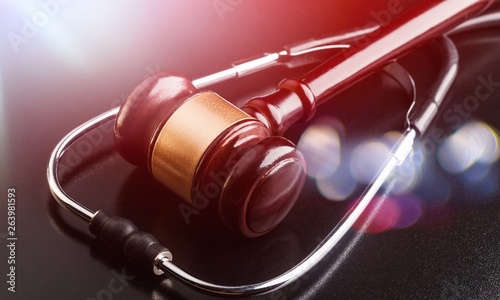 Wooden gavel and stethoscope, close-up view