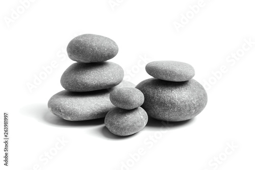 Stacked pebbles isolated on white background. Group of smooth grey stones. Sea pebble