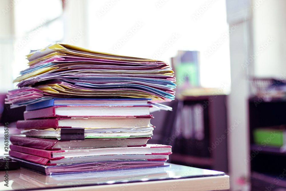 Stack of documents placed on a business desk in a business office. Stack of documents placed on a business desk in a business office.