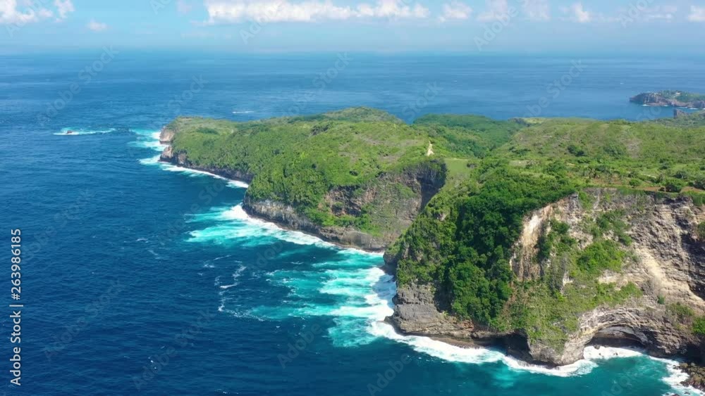 Aerial view at sea and rocks. Turquoise water background from top view. Summer seascape from air. Kelingking beach, Nusa Penida, Bali, Indonesia. Travel - image Aerial view at sea and rocks. Turquoise water background from top view. Summer seascape from air. Kelingking beach, Nusa Penida, Bali, Indonesia. Travel - image