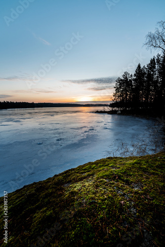 Sunrise by icy lake