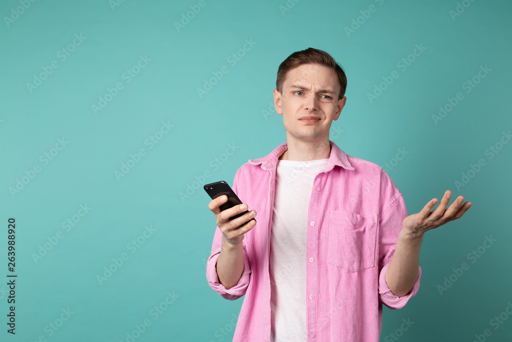 Half lenght portrait of a confused unhappy man in pink shirt Half lenght portrait of a confused unhappy man in pink shirt