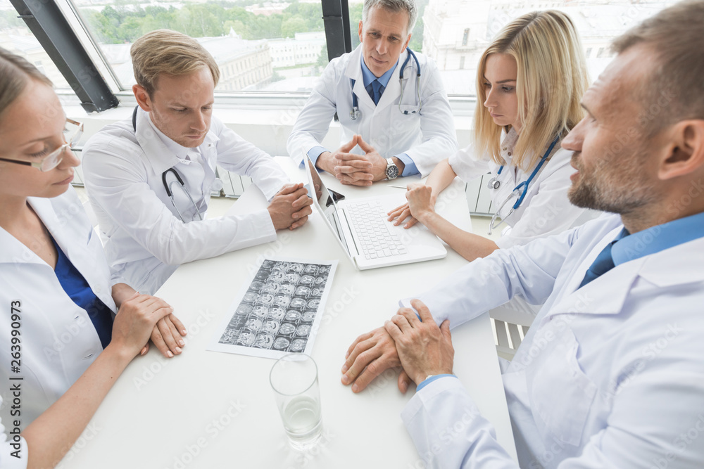 Team of doctors discuss brain scan Team of doctors discuss brain scan