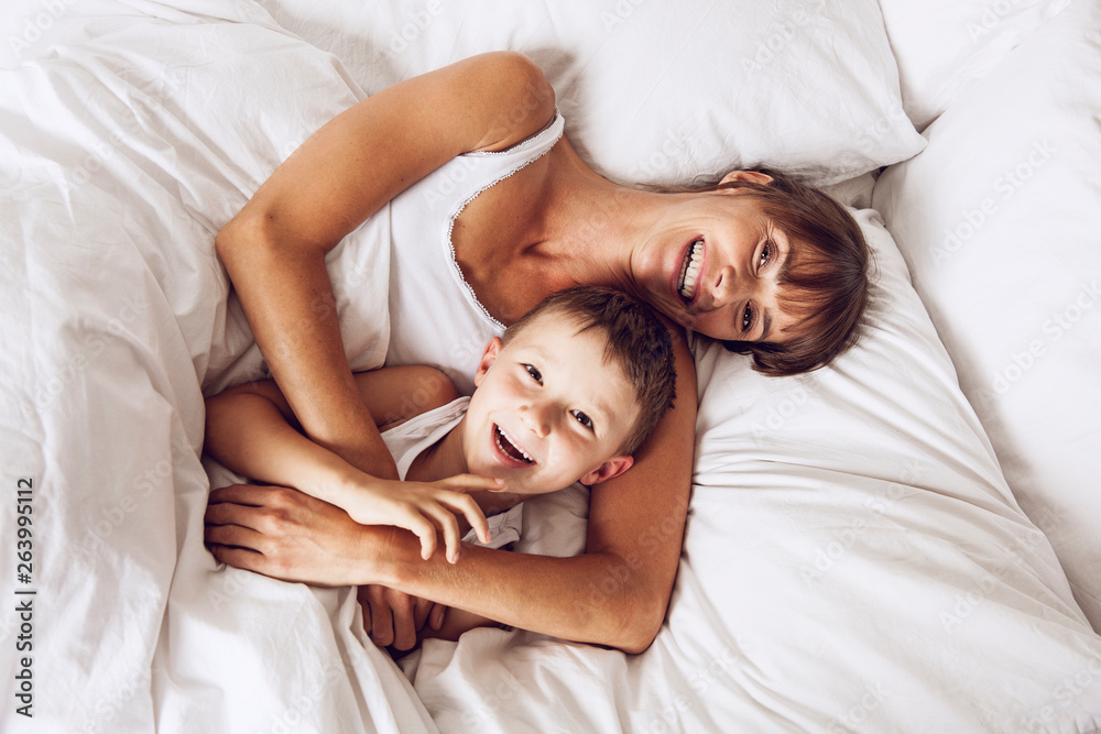 Mother and son cuddling in bed Mother and son cuddling in bed