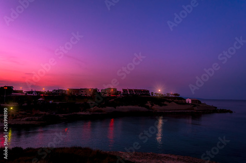 Seascape at purple sunset of the coast