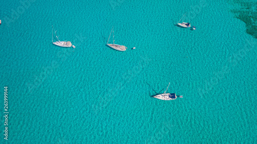 Amazing drone aerial landscape of the charming area of Es Trencs and the boats with a turquoise sea. It has earned the reputation of Caribbean beach of Mallorca. Spain © Matteo Ceruti