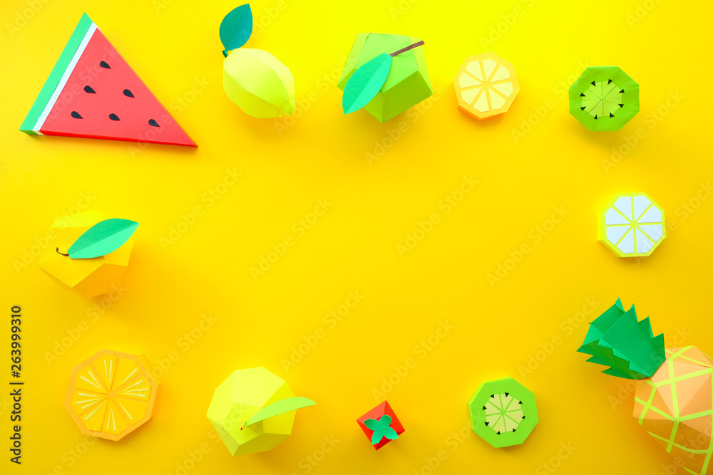 exotic fruits made of paper on yellow background