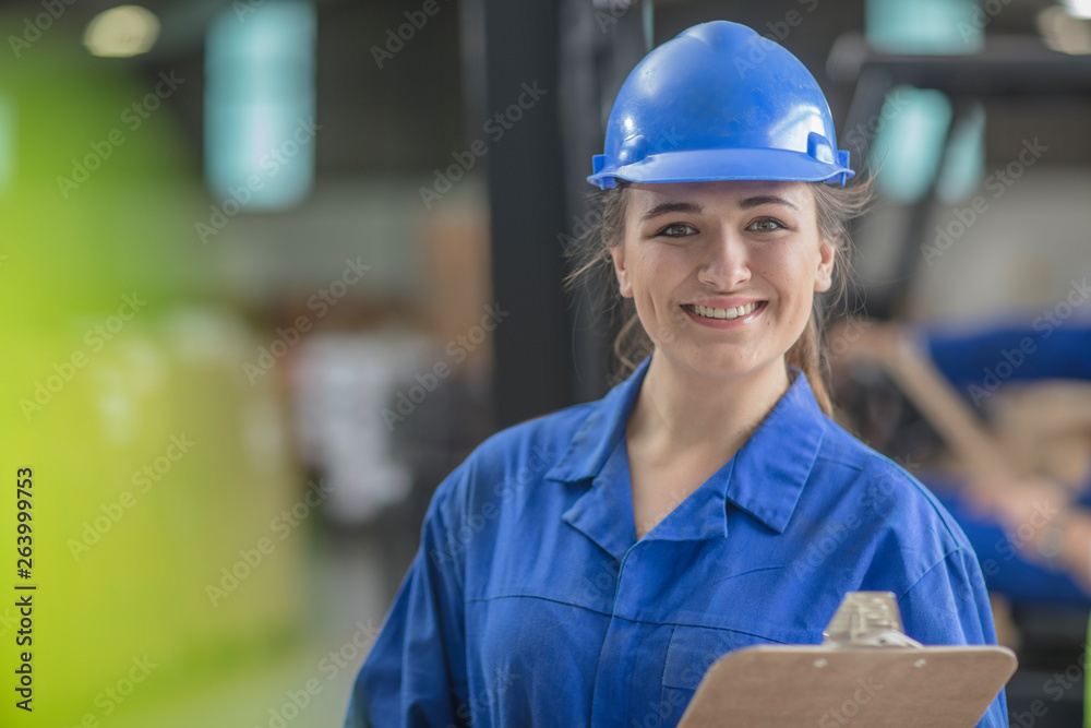 Portrait of smiling woman wearing hard hat in factory Portrait of smiling woman wearing hard hat in factory