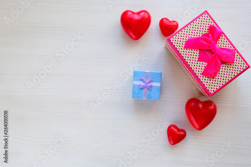 gift box surrounded by hearts on a white table. Present. Place for inscription. Mothers Day