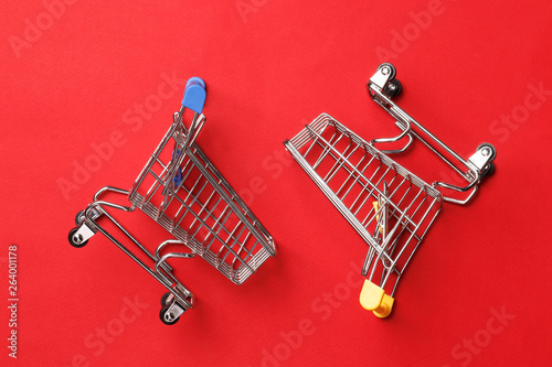 Shopping concept. Two shopping carts on a red background.