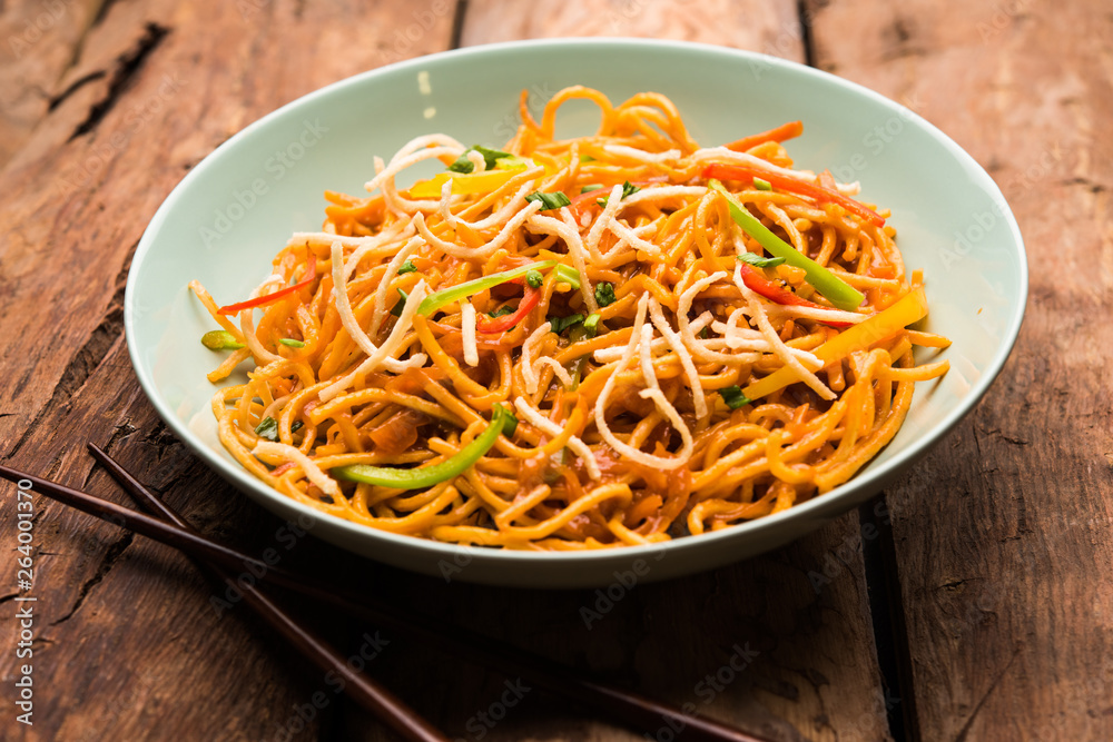 American chop suey/ chopsuey is a popular indochinese food. served in a bowl with chop sticks. selective focus American chop suey/ chopsuey is a popular indochinese food. served in a bowl with chop sticks. selective focus