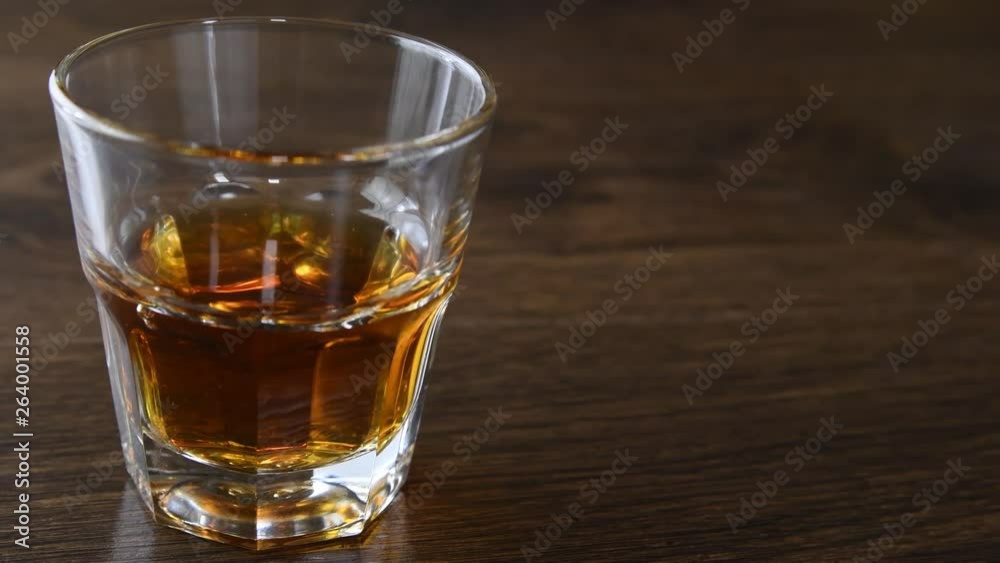 Poured from a bottle whiskey drink on whiskey glass Poured from a bottle whiskey drink on whiskey glass