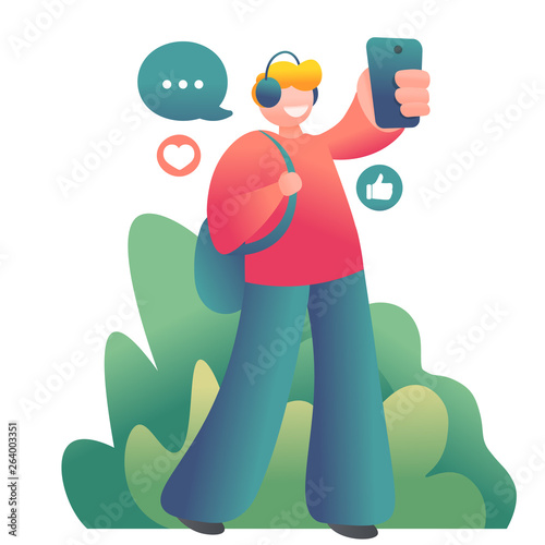 young guy walking on the street and making selfie on smartphone