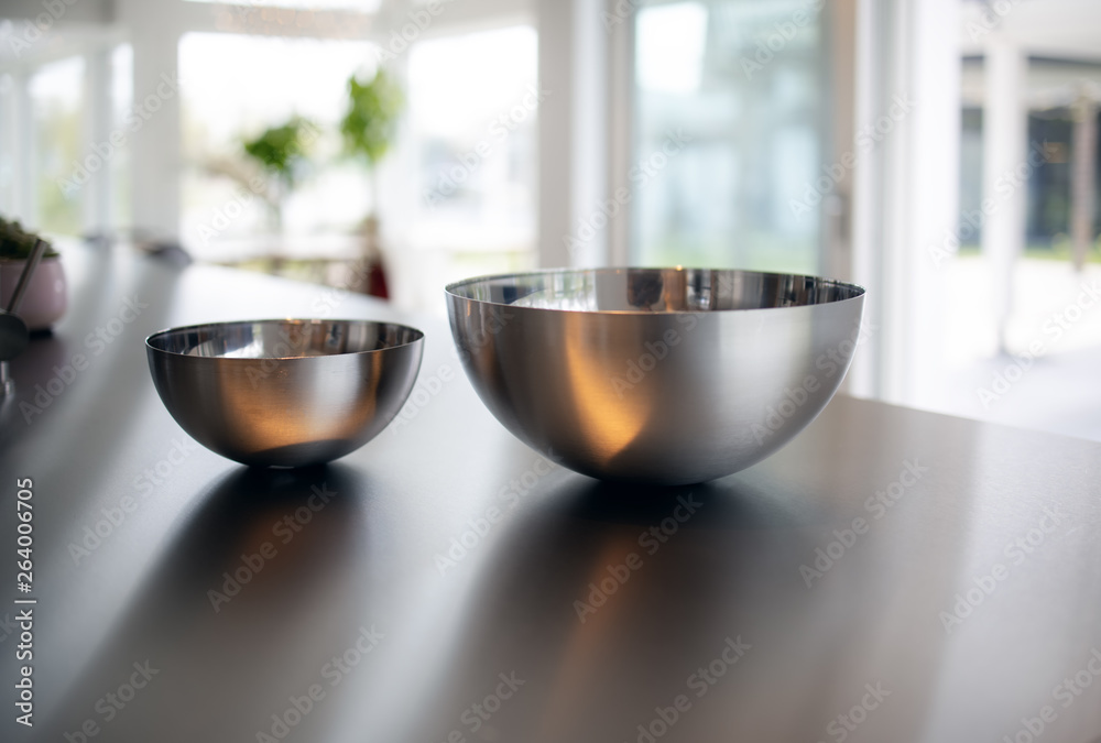 Two metal bowls in a modern kitchen. Minimalistic interior kitchen design Two metal bowls in a modern kitchen. Minimalistic interior kitchen design
