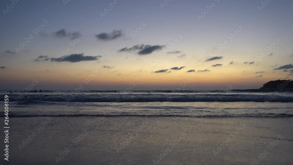 Beautiful sunset overlooking the sea and the horizon. The sound of waves can be heard, the island can be seen in the distance. Everything shimmers in yellow. The waves are gradually rolling. Beautiful sunset overlooking the sea and the horizon. The sound of waves can be heard, the island can be seen in the distance. Everything shimmers in yellow. The waves are gradually rolling.