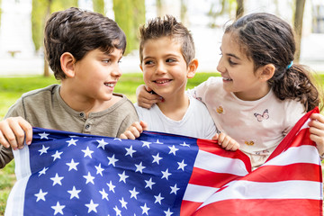Three kids celebrating 4th of July outdoors