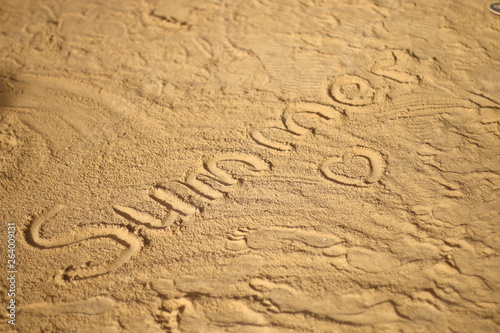 heart and the inscription  summer  on the sand