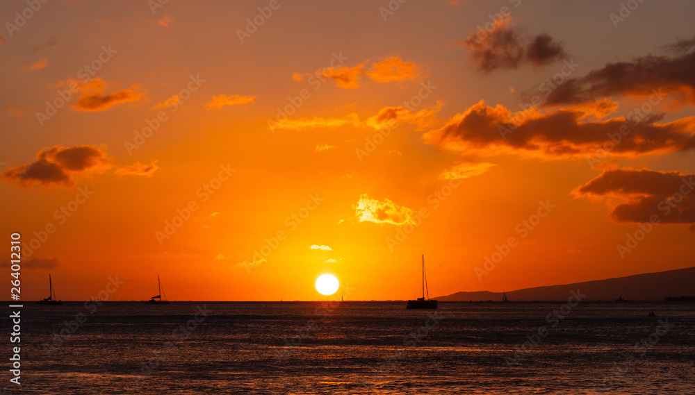 Orange and golden sunset at Waikiki Beach Hawaii