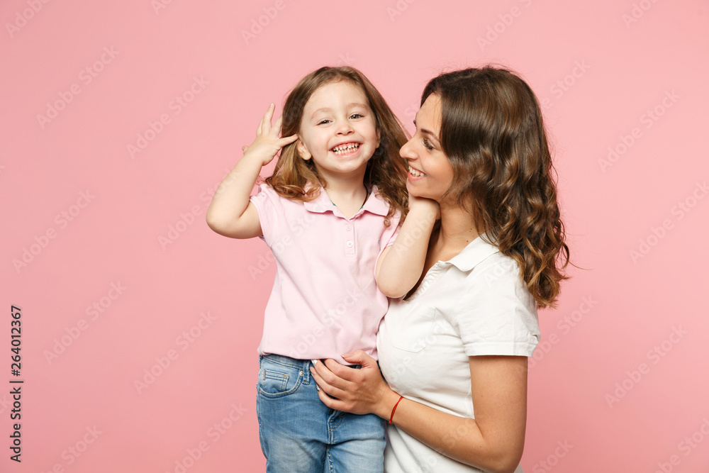 Woman in light clothes have fun with cute child baby girl. Mother, little kid daughter isolated on pastel pink wall background, studio portrait. Mother's Day, love family, parenthood childhood concept Woman in light clothes have fun with cute child baby girl. Mother, little kid daughter isolated on pastel pink wall background, studio portrait. Mother's Day, love family, parenthood childhood concept