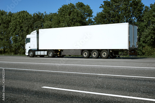 White truck is going up the road. Cargo transportation concept.