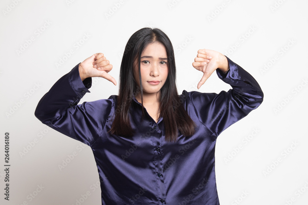 Unhappy Asian girl show thumbs down with both hands. Unhappy Asian girl show thumbs down with both hands.
