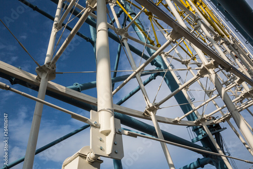 Photo of Architectural details of the metallic structure of a big ferris wheel. Old, rustic carousel details for web or app usage
