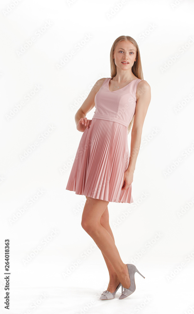 Naklejka premium Beautiful young blonde woman in pink dress isolated on white background