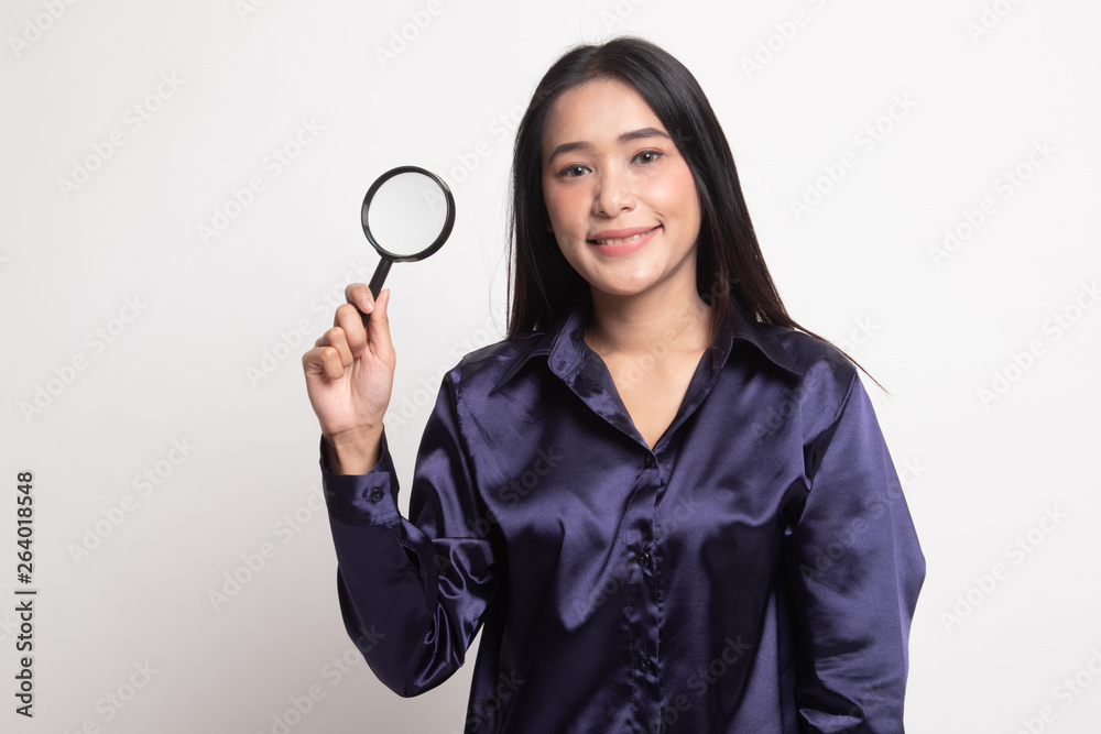 Young Asian woman with a magnifying glass. Young Asian woman with a magnifying glass.
